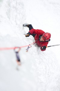 Man Ice Climbing in Mountains